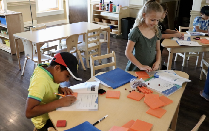 3rd and 4th grade students using math manipulatives